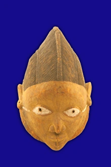 <b class=qtipBold><figcaption>gelede mask, Nigerian, 1800-1878</figcaption></b><br>Carved from one piece of wood. Cranial area carved to represent hair and is pigmented black. The eyes are pierced and pigmented white with red rims. From each ear a thick white line bordered with red runs to the corner of each eye. gelede mask, Nigerian, 1800-1878