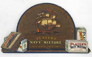 <b class=qtipBold><figcaption>Navy Mixture tobacco, 1927</figcaption></b><br>Player's Navy Mixture tobacco counter card. The centre of the card is domed and depicts a galleon in full sail. Either side are packs of Navy mixture medium and white label tobacco. The text reads "AN ENGLISH MAN-OF-WAR OF THE EARLY SIXTEENTH CENTURY // PLAYER'S // "NAVY" MIXTURE // "MILD", "MEDIUM" & "WHITE LABEL". On the reverse is a support to allow the card to stand upright and a hanging loop. There are three handwritten notes which read "1927"; "APPROX DATE 1927" and "C111". There is a label which reads "MARDONS // WINDOW NOVELTIES // EMBOSSED SHOWCARDS / &C, &C // VARNISHERS // GELATINERS & FRAME MAKERS // BRISTOL & LONDON.".<br><em>© Produced by the kind permission of Imperial Tobacco Limited, England </em> Navy Mixture tobacco, 1927